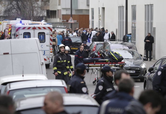 Firefighters push a stretcher outside the headquarters of the French satirical newspaper Charlie Hebdo in Paris on January 7, 2015, after armed gunmen stormed the offices leaving twelve dead, including three police officers, according to sources close to the investigation. (AFP Photo / Kenzo Tribouillard)