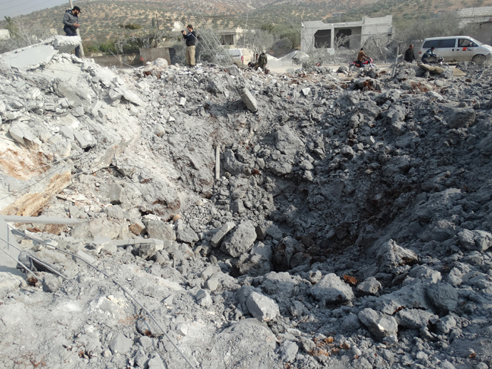 Syrians inspect a crater following a reported US-led coalition air strike in the town of Harem in the northwestern province of Idlib, bordering Turkey (AFP Photo / Mohamad Zeen)