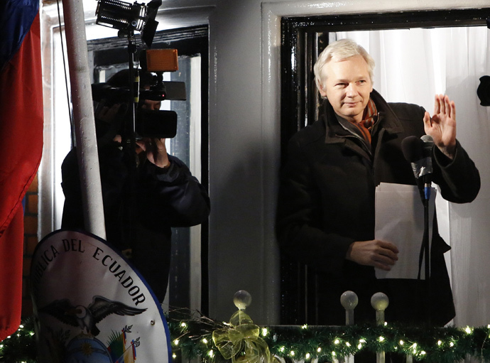 WikiLeaks founder Julian Assange gestures from the balcony of Ecuador's Embassy as he makes a speech, in central London (Reuters / Luke MacGregor)