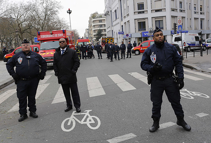 Policemen work at the scene after a shooting at the Paris offices of Charlie Hebdo January 7, 2015. (Reuters/Youssef Boudlal)