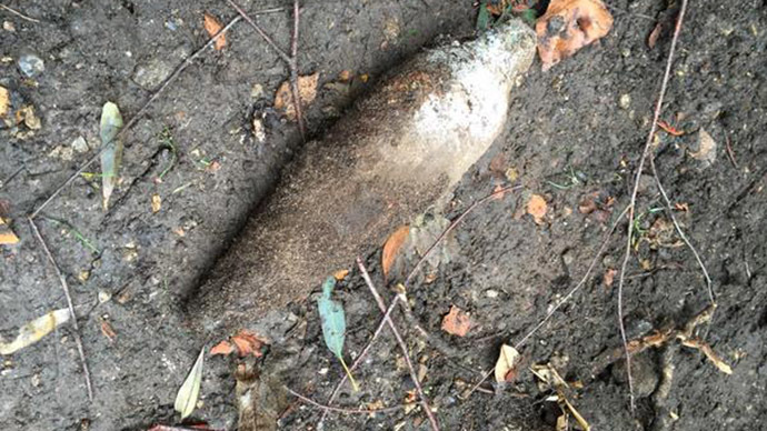 World War II bomb unearthed in North London" and "Crater left following controlled explosion. (both c/o Marcus Fairs)