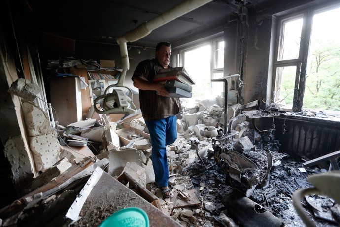 A man inspects wreckage inside a damaged building following what locals say was shelling by Ukrainian forces in Donetsk (Reuters / Sergei Karpukhin)
