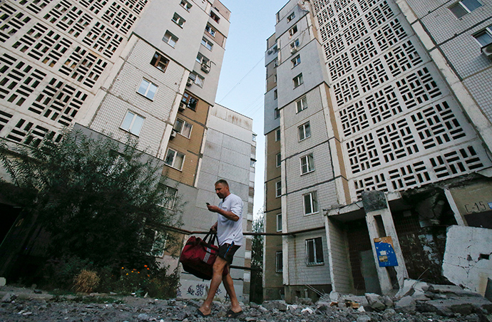 A man walks on rubble near an apartment block damaged by what locals say was shelling by Ukrainian forces in Donetsk (Reuters / Maxim Shemetov)