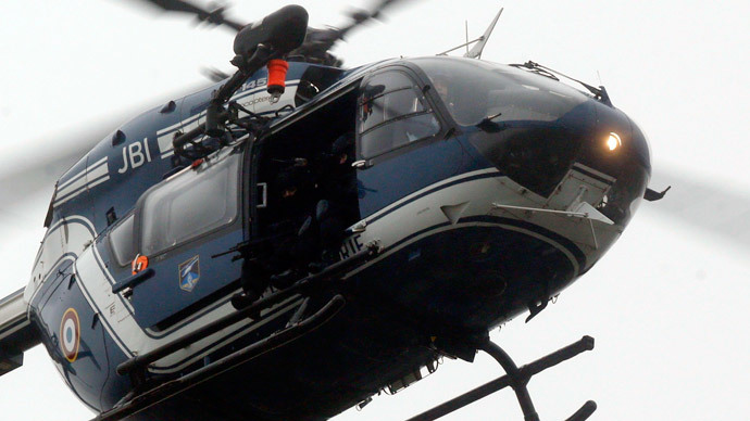 A helicopter with members of the French intervention gendarme forces hover above the scene of a hostage taking at an industrial zone in Dammartin-en-Goele, northeast of Paris January 9, 2015.(Reuters / Christian Hartmann)