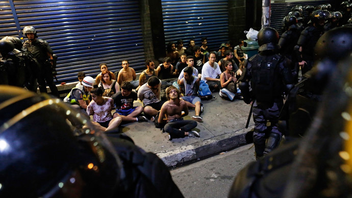 Demonstrators are detained by riot police during a protest against fare hikes for city buses, subway and trains in Sao Paulo January 9, 2015. (Reuters / Nacho Doce)