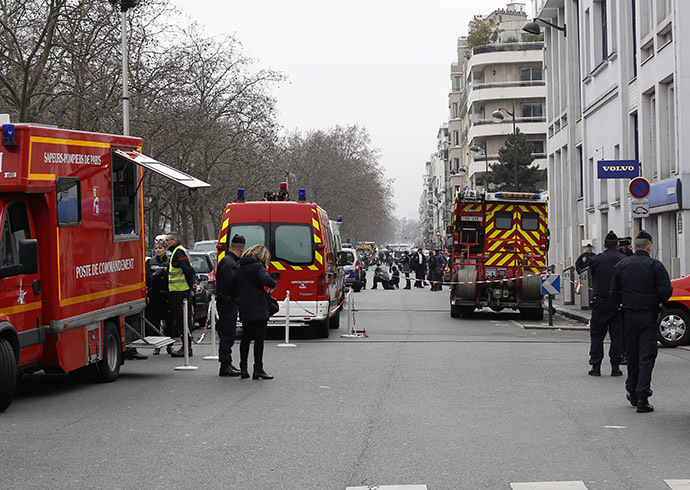 Policemen work at the scene after a shooting at the Paris offices of Charlie Hebdo January 7, 2015. (Reuters/Youssef Boudlal)
