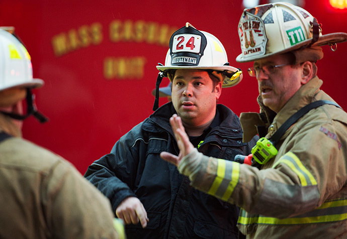 Firefighters confer after passengers on the Metro (subway) service were injured when smoke filled the L'Enfant Plaza station during the evening rush hour January 12, 2015 in Washington, DC. (AFP Photo/Paul J. Richards)