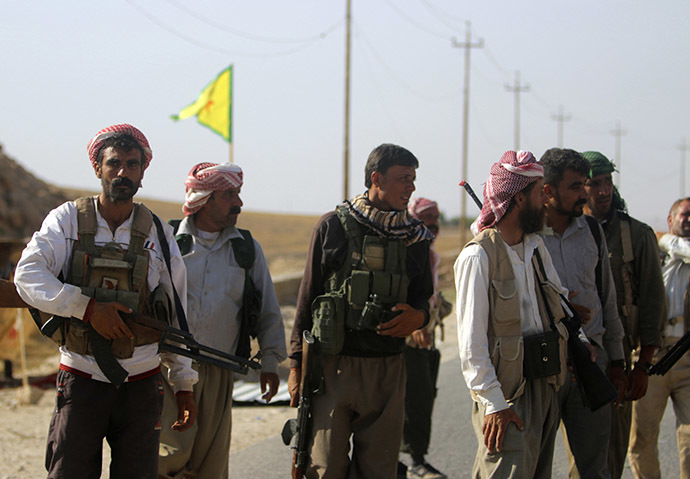 Yazidi fighters who recently joined the Kurdish People's Protection Units (YPG) secure a road in Mount Sinjar in northern Iraq. (Reuters/Rodi Said)