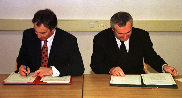 British Prime Minister Tony Blair (L) and Irish Prime Minister Bertie Ahern sign the peace agreement April 10, 1998 (Reuters)