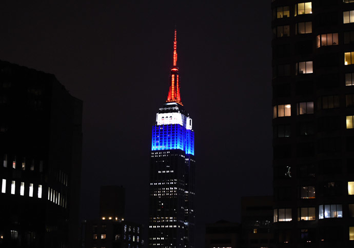 The Empire State building is lighted up in the colors of the French flag to pay tribute to those that lost their lives in the terrorist attacks at Charlie Hedbo on January 11, 2015 in New York. (AFP Photo / Timothy A. Clary)