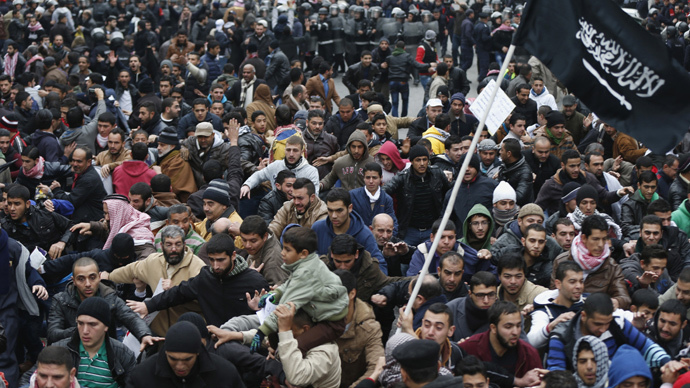 Protesters run to escape security forces after they tried to reach the French embassy during a protest against satirical French weekly newspaper Charlie Hebdo, after the Friday prayer in Amman January 16, 2015. (Reuters / Muhammad Hamed)