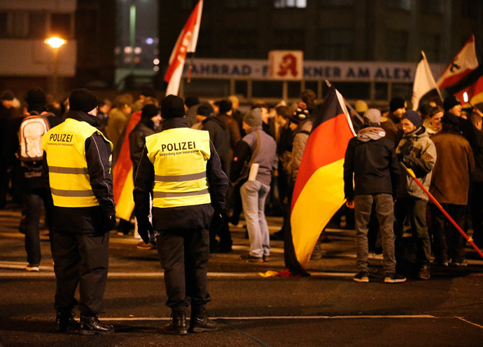 German police officers watch as members of BAERGIDA, Berlin's section of anti-immigration movement Patriotic Europeans Against the Islamisation of the West (PEGIDA) prepare to demonstrate in Berlin January 19, 2015. (Reuters / Fabrizio Bensch)