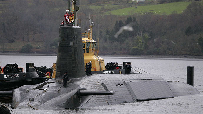 Crew from HMS Vengeance, a British Royal Navy Vanguard class Trident Ballistic Missile Submarine, stand on their vessel as they return along the Clyde river to the Faslane naval base near Glasgow, Scotland. (Reuters/David Moir)