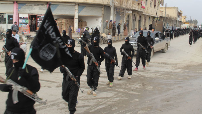 Fighters of al-Qaeda linked Islamic State of Iraq and the Levant carry their weapons during a parade at the Syrian town of Tel Abyad, near the border with Turkey January 2, 2014. (Reuters/Yaser Al-Khodor)