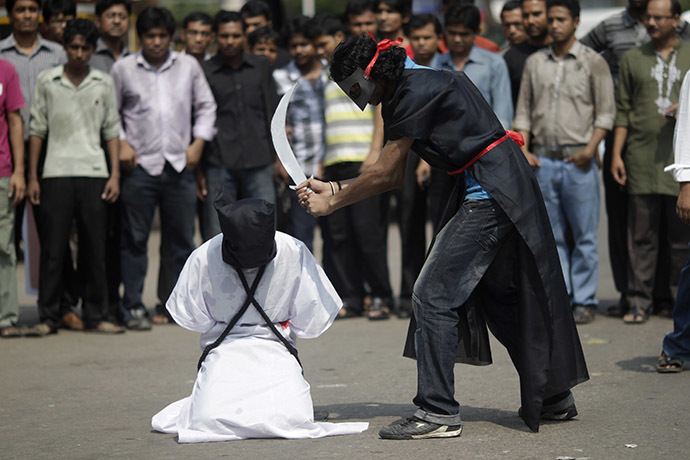 FILE PHOTO: Members of Magic Movement stage a mock execution scene in protest of Saudi Arabia beheading of eight Bangladeshi workers in October 2011. (Reuters/Andrew Biraj)