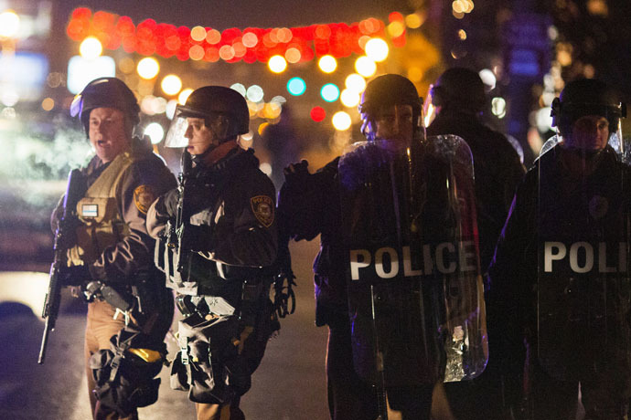 Police officers clear a street of protesters during a second night of unrest in Ferguson, Missouri, November 26, 2014. (Reuters/Lucas Jackson)