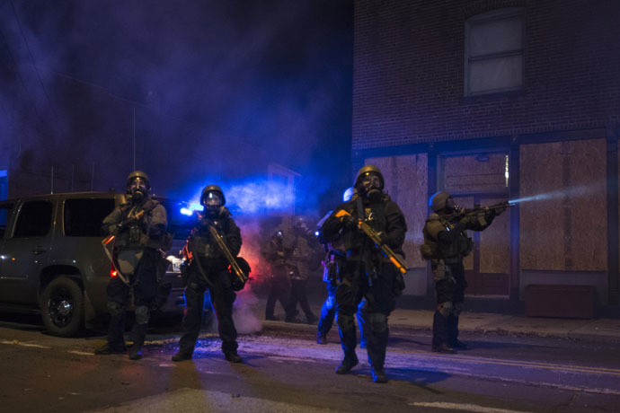 Police in riot gear stand guard after deploying tear gas to disperse protesters in Ferguson, Missouri, November 25, 2014. (Reuters/Adrees Latif)