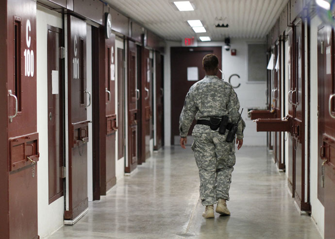 A guard walks through a cellblock inside Camp V, a prison used to house detainees at Guantanamo Bay U.S. Naval Base (Reuters/Bob Strong)