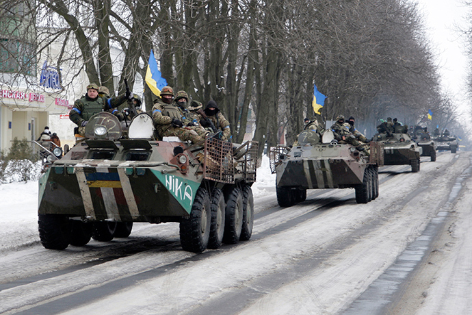 Members of the Ukrainian armed forces drive armored vehicles in the town of Volnovakha, eastern Ukraine (Reuters / Alexander Ermochenko)