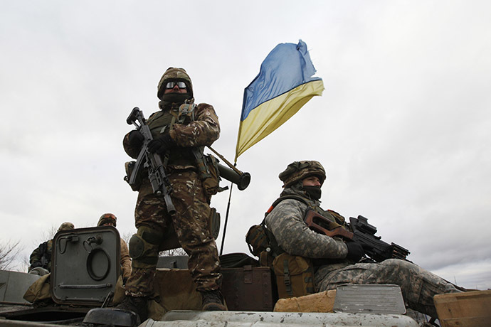 Ukrainian servicemen ride on an armored personnel carrier (APC) at a checkpoint near the eastern Ukrainian town of Debaltsevo in Donetsk region, December 24, 2014. (Reuters/Valentyn Ogirenko)