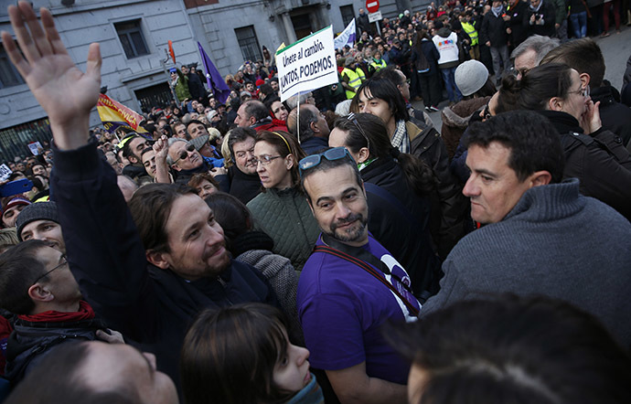 Pablo Iglesias (L), leader of Spain's party "Podemos" (We Can) waves as he attends a rally called by Podemos in Madrid January 31, 2015. (Reuters/Sergio Perez)