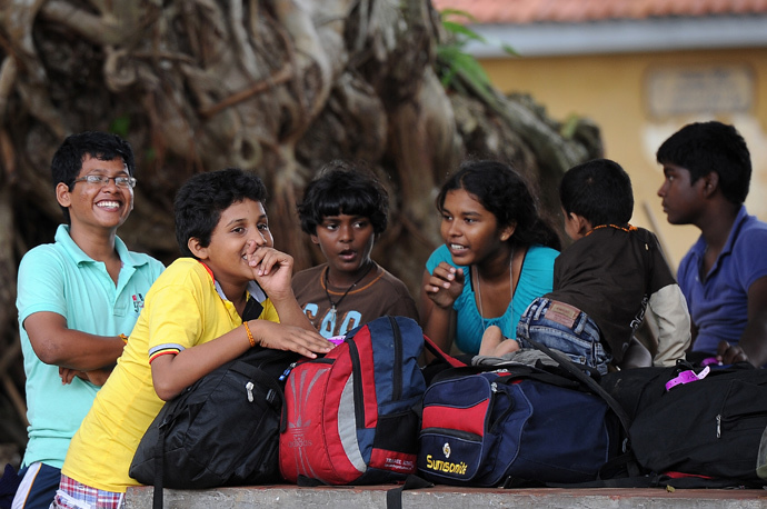 ARCHIVE PHOTO: Sri Lankan children among a group of Sri Lankan asylum seekers sent back by Australia wait outside the magistrate's court in the southern port district of Galle on July 8, 2014. (AFP Photo / Lakruwan Wanniarachchi)