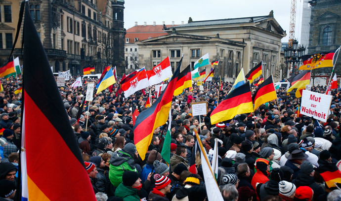 Members of the movement of Patriotic Europeans Against the Islamisation of the West (PEGIDA) hold flags and banners during a PEGIDA demonstration march in Dresden, January 25, 2015. (Reuters / Hannibal Hanschke)