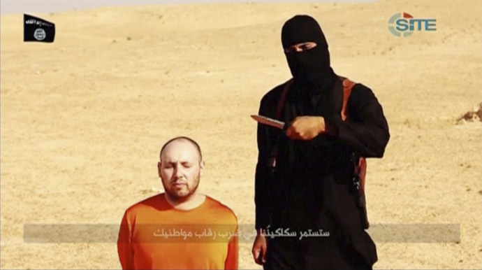 A masked, black-clad militant, who has been identified by the Washington Post newspaper as a Briton named Mohammed Emwazi, stands next to a man purported to be Steven Sotloff in this still image from a video obtained from SITE Intel Group website February 26, 2015. (Reuters/SITE Intel Group)