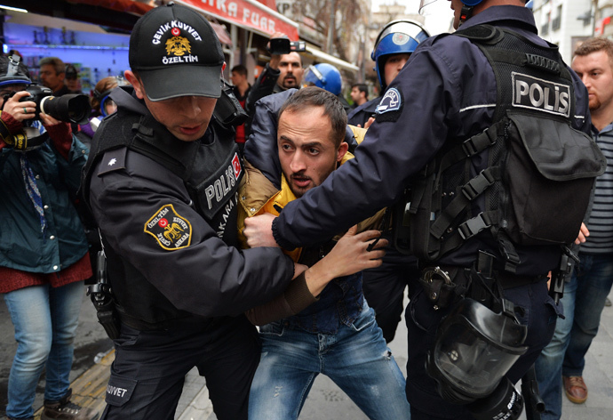 Riot police detain a demonstrator during a protest in Ankara March 11, 2015. (Reuters / Stringer)