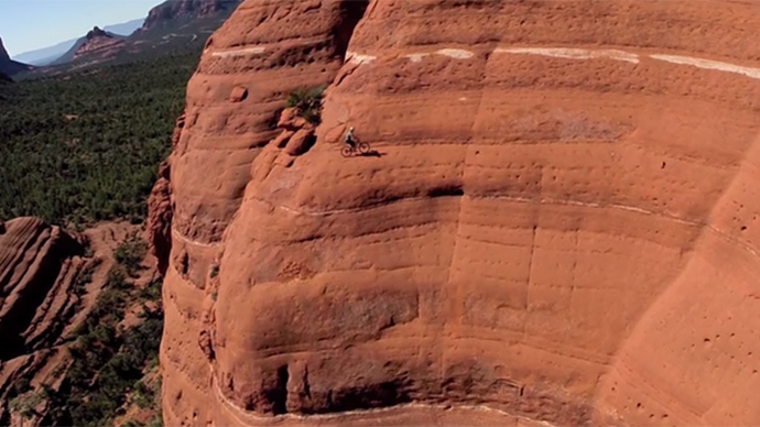 Stunning drone footage of bike daredevil riding vertical cliff face in Arizona (VIDEO)