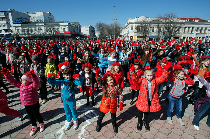 Children take part in the flash mob segment of the "This is dedicated to you, Russia!" theatrical performance to celebrate the first anniversary of Russia's annexation of Ukraine's Black Sea peninsula of Crimea, in central Simferopol March 14, 2015 (Reuters / Maxim Shemetov)