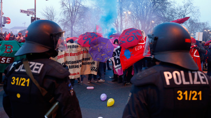 Anti-capitalist 'Blockupy' protesters stand in front of a police cordon near the European Central Bank (ECB) building before the official opening of its new headquarters in Frankfurt March 18, 2015. (Reuters / Michael Dalder )