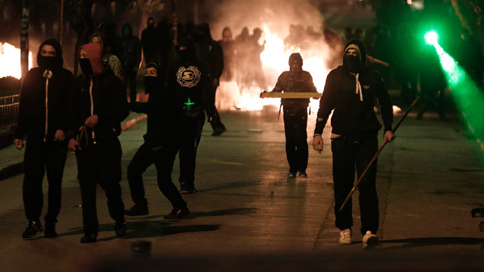 Greek protesters target police, torch cars in Athens demanding prison closure