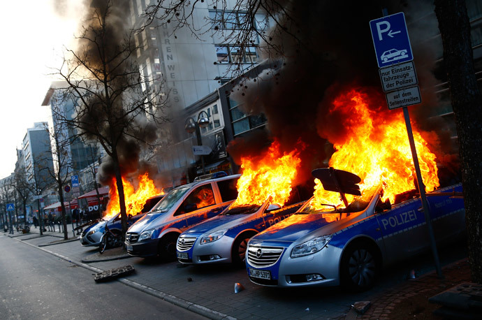 Four German police cars set on fire by anti-capitalist protesters burn near the European Central Bank (ECB) building hours before the official opening of its new headquarters in Frankfurt March 18, 2015. (Reuters / Kai Pfaffenbach)