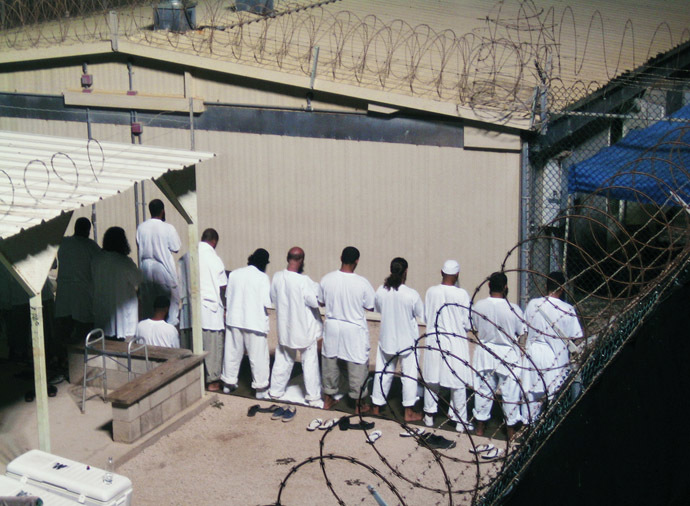 Detainees participate in an early morning prayer session at Camp IV at the detention facility in Guantanamo Bay U.S. Naval Base. (Reuters / Deborah Gembara)