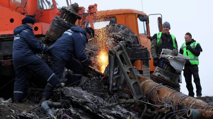 Local workers cut wreckage of the Malaysia Airlines Boeing 777 plane (flight MH17) at the site of the plane crash near the settlement of Grabovo in the Donetsk region November 16, 2014.(Reuters / Antonio Bronic)