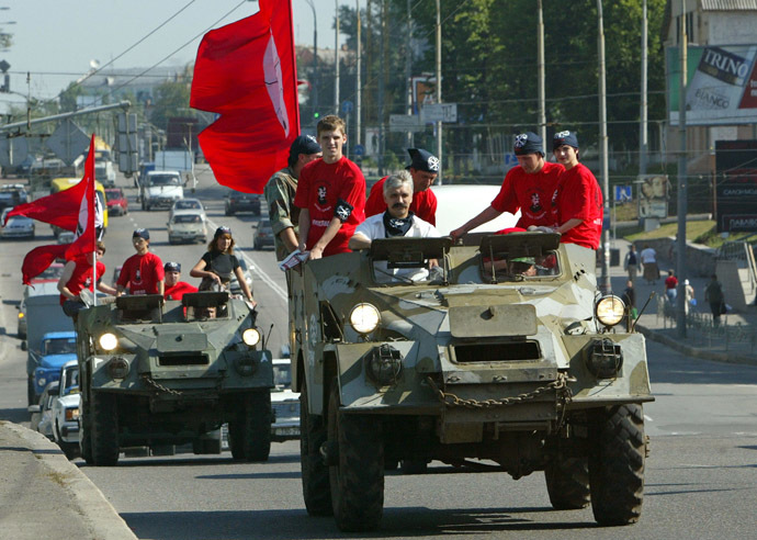 Representatives of the Ukrainian Radical Brotherhood movement and their leader Dmytro Korchynsky (2L) ride armoured personnel carriers towards the Central Election Commission in Kiev, July 19, 2004. (Reuters / Stringer)