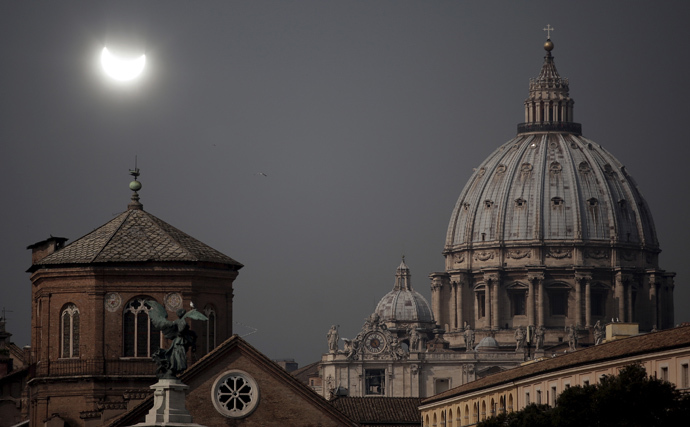 A partial solar eclipse is seen over St.Peter's Basilica in Rome March 20, 2015.(Reuters / Yara Nardi)