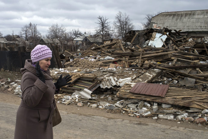 A woman reacts as she passes a destroyed house in the town of Debaltseve, north-east from Donetsk, March 17, 2015. (Reuters/Marko Djurica)