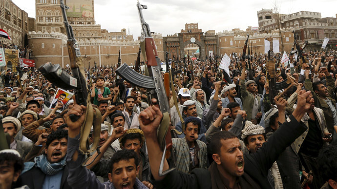 Shi'ite Muslim rebels hold up their weapons during a rally against air strikes in Sanaa March 26, 2015. (Reuters/Khaled Abdullah)