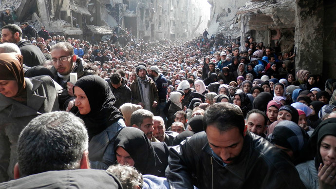 Residents wait to receive food aid distributed by the U.N. Relief and Works Agency (UNRWA) at the besieged al-Yarmouk camp, south of Damascus on January 31, 2014, in this handout picture made available to Reuters February 26, 2014..(Reuters / UNRWA)