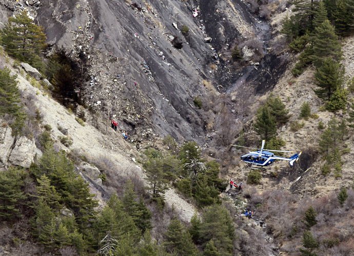 A French gendarme helicopter flies over the moutainside crash site of an Airbus A320, near Seyne-les-Alpes, March 25, 2015. (Reuters/Emmanuel Foudrot)