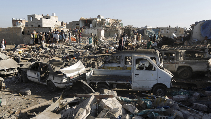 People gather at the site of an air strike at a residential area near Sanaa Airport (Reuters / Khaled Abdullah)