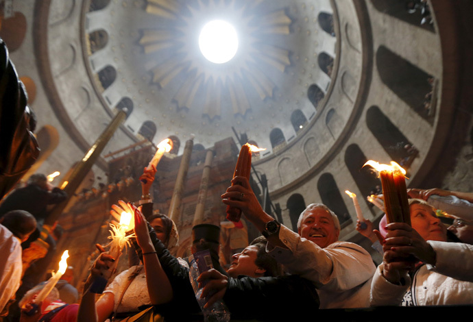 Worshippers hold candles as they take part in the Christian Orthodox Holy Fire ceremony at the Church of the Holy Sepulchre in Jerusalem's Old City, April 11, 2015. (Reuters/Ammar Awad)