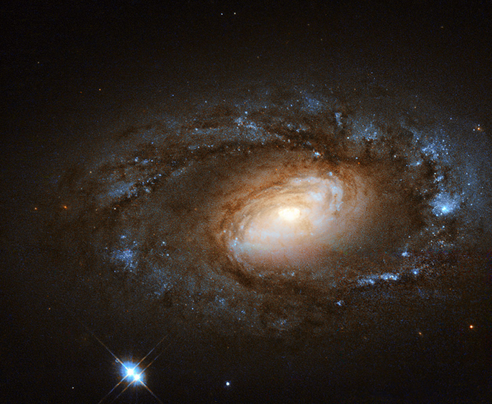 Hubble Spies Charming Spiral Galaxy Bursting with Stars. (Image from Flickr/Credit: NASA, ESA, and M. Livio and the Hubble 20th Anniversary Team (STScI)