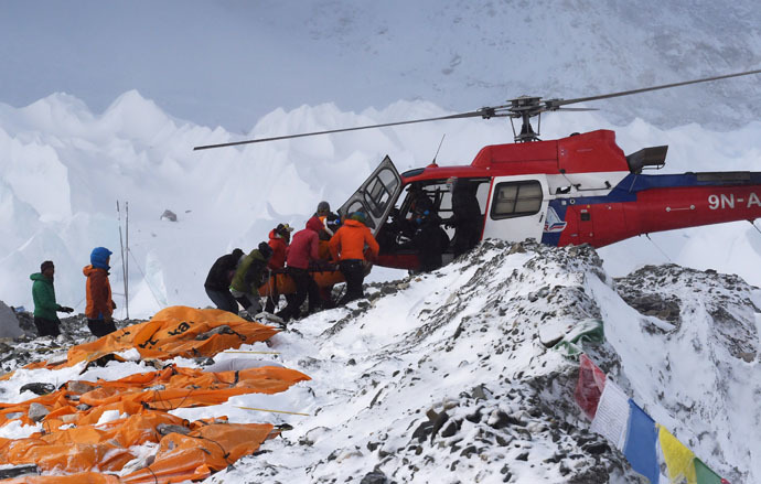 An injured person is loaded onto a rescue helicopter at Everest Base Camp on April 26, 2015, a day after an avalanche triggered by an earthquake devastated the camp. (AFP Photo/Roberto Schmidt)