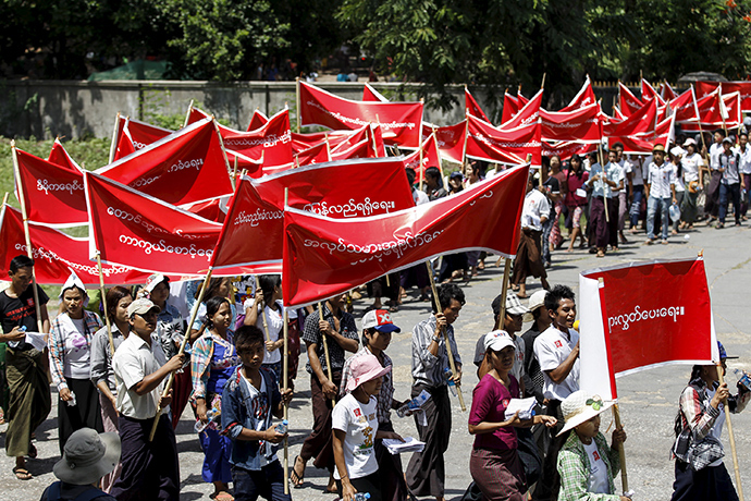 Workers carry banners with messages in support of workers' rights during a march to mark Labour Day in Yangon May 1, 2015 (Reuters / Soe Zeya Tun)