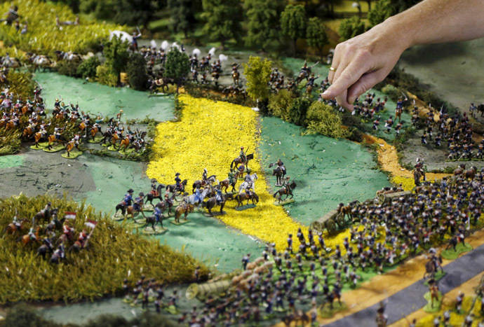 Waterloo enthusiast Willy Smout, 56, points at a figurine representing French Emperor Napoleon (C on white horse) on a 40-square-metre miniature model of the June 18, 1815 Waterloo battlefield, in Diest, Belgium, in this picture taken on April 29, 2015. (Reuters/Francois Lenoir)