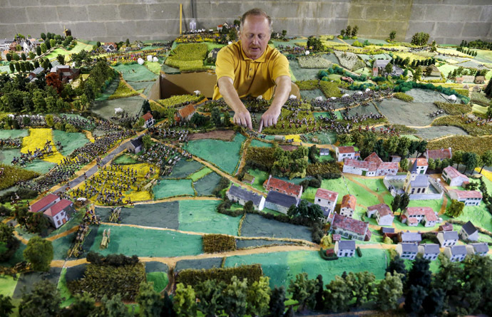 Waterloo enthusiast Willy Smout, 56, adjusts figurines on a 40-square-metre miniature model of the June 18, 1815 Waterloo battlefield, in Diest, Belgium, in this picture taken on April 29, 2015. (Reuters/Francois Lenoir)