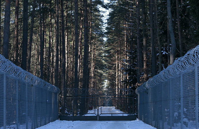 Barbed wire fence surrounding a military area is pictured in the forest near Stare Kiejkuty village, close to Szczytno in northeastern Poland. (Reuters/Kacper Pempel)
